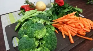 Fresh vegetables on a cutting board ready for a sustainable meal.