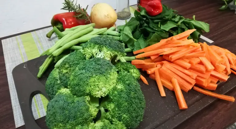 Fresh vegetables on a cutting board ready for a sustainable meal.